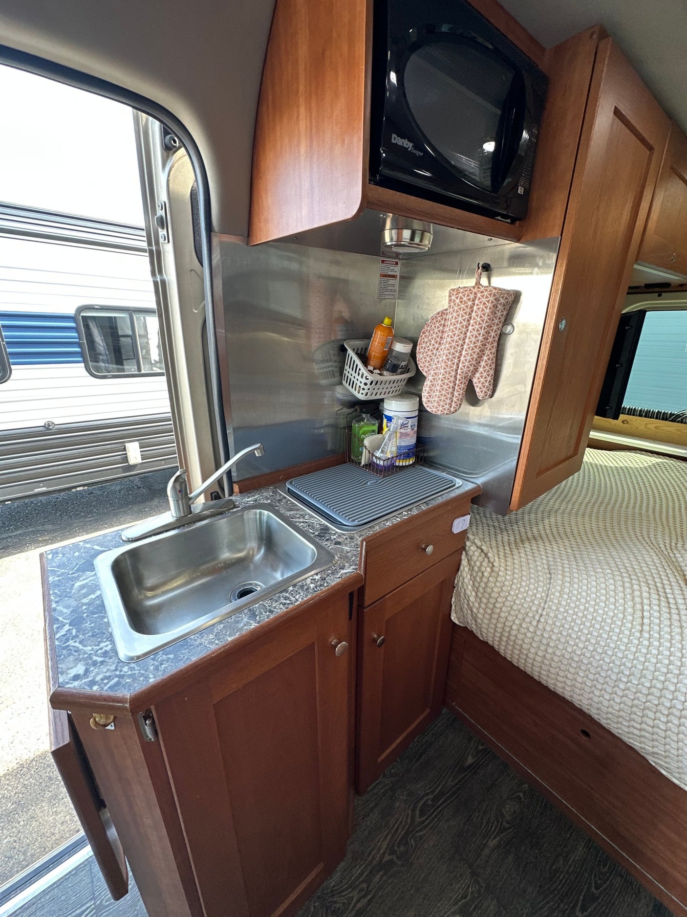 parked outdoors.|RV rental interior: A comfortable bed