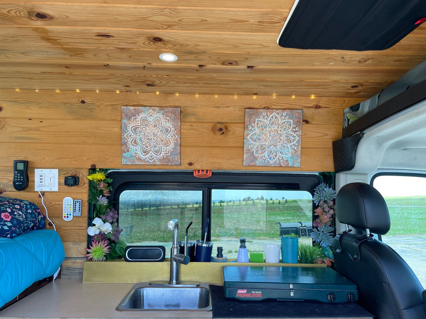 overlooks Boulder Flatirons & green valley. Stunning mountain view.|White camper van RV rental with open side door revealing a wood-paneled — photo 8