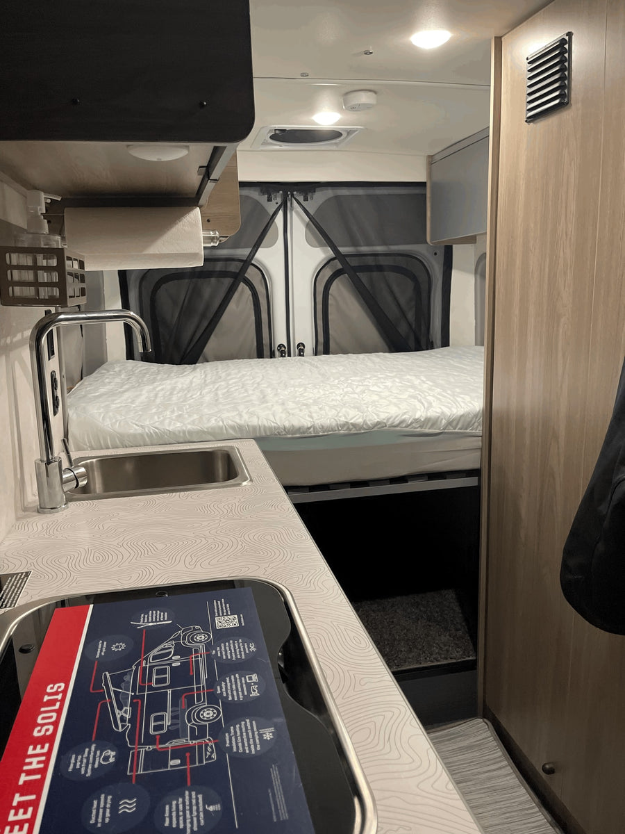 and camping accessories.|RV rental interior: open white refrigerator