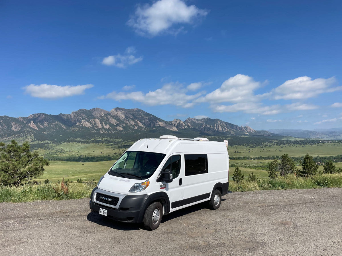 White rv rental campervan on a gravel road