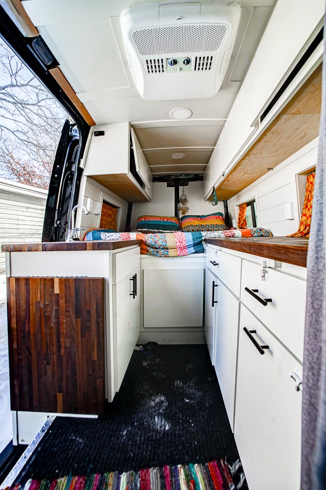 ready for adventure.|Rear view of an RV rental van in a snowy driveway