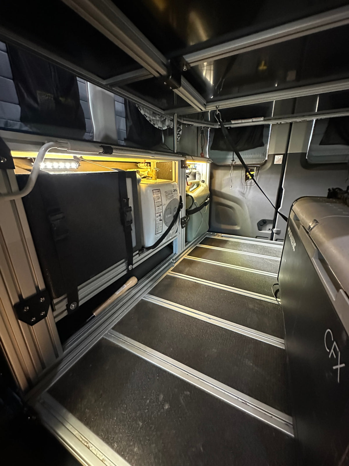 parked outside on a sunny day. Ideal for your next RV rental trip.|Spacious RV rental camper van interior with modular storage — photo 5