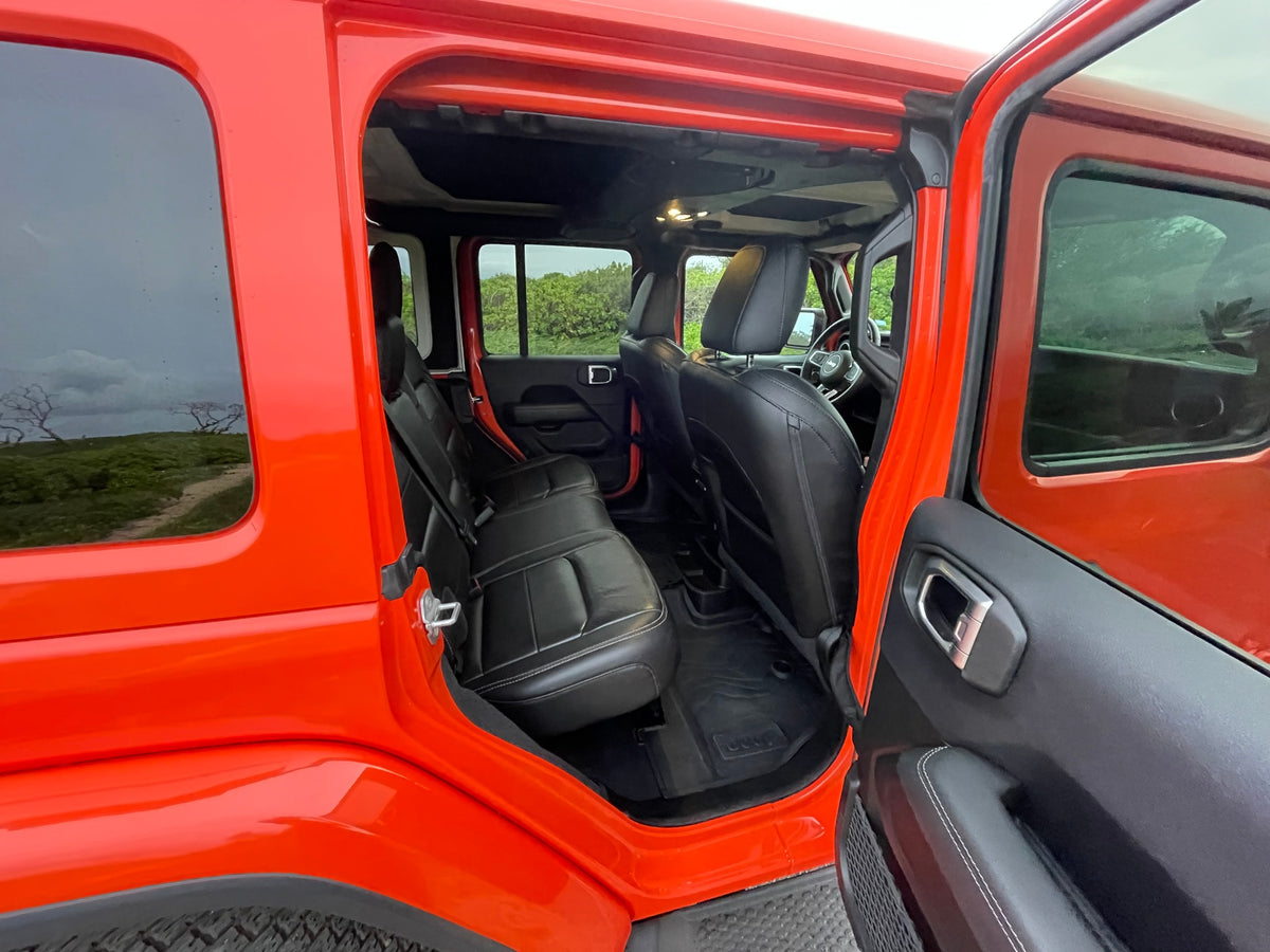 a great option for any RV rental road trip.|Inside a modern Jeep looking out at a scenic coastal road and mountains. Ideal for an adventurous rv rental trip.|Interior of a vibrant orange Jeep — photo 26