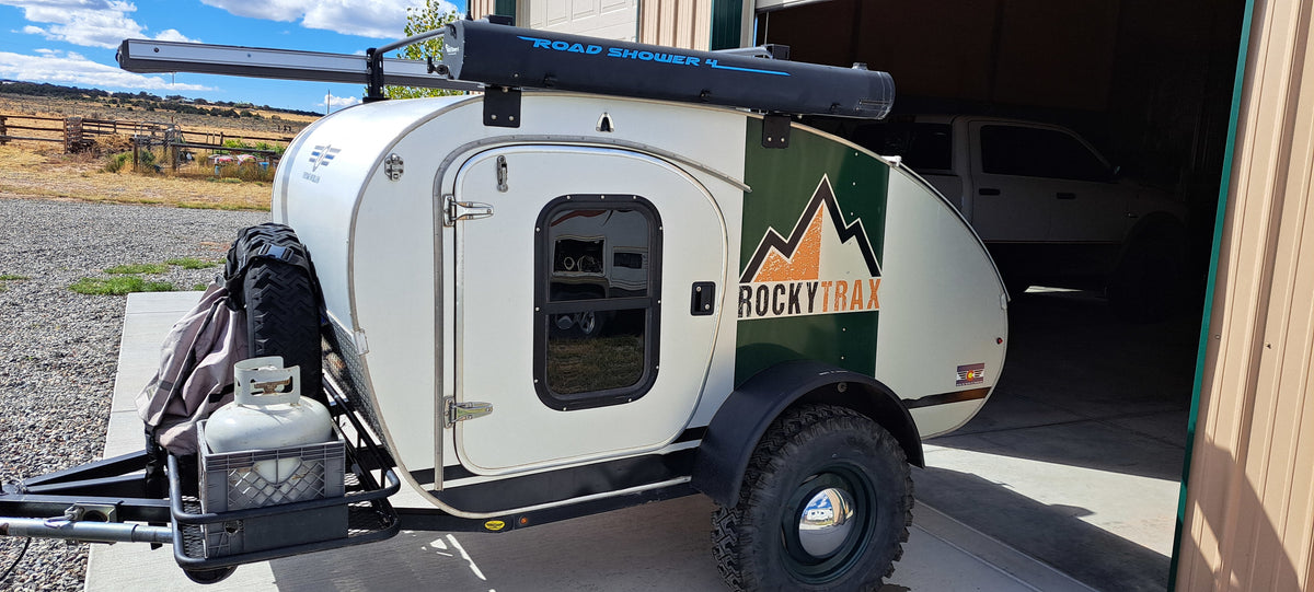 This rugged RockyTrax teardrop camper, great for RV rental and off-road adventures, features a roof shower & spare tire. — photo 8