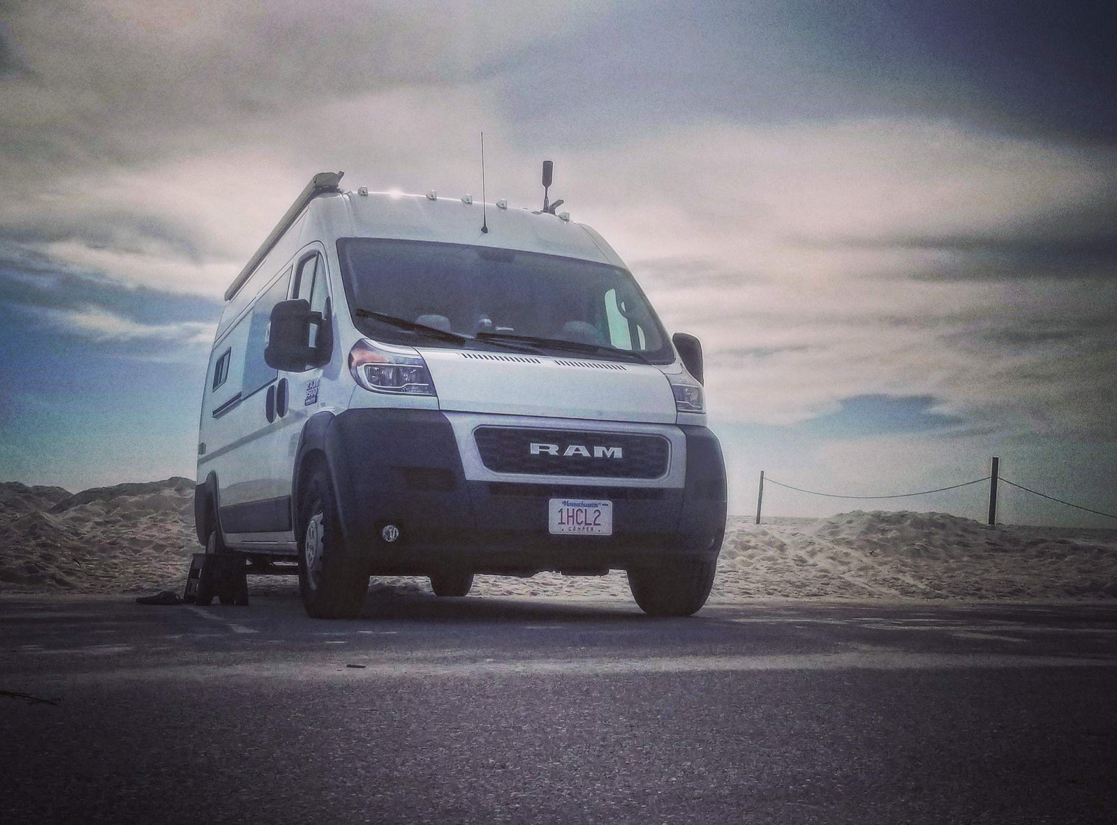 and warm ambient lighting.|This inviting RV rental camper van interior features blue upholstered seating