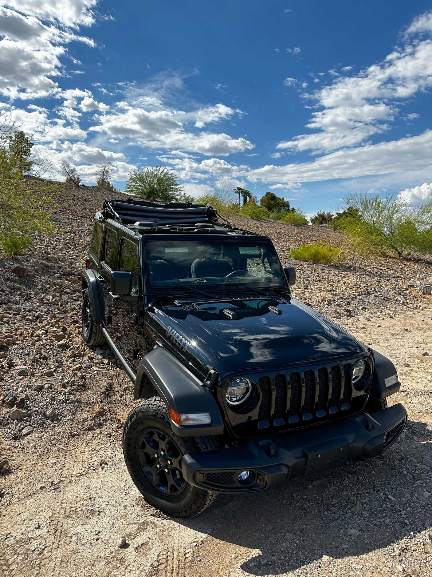 Black Jeep Wrangler on rocky trail, offering a different adventure than an RV rental.