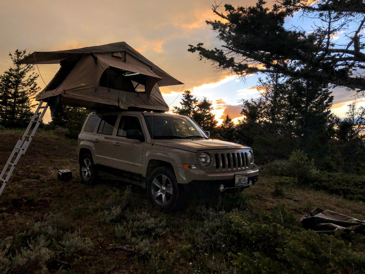 Golden hour camping: a Jeep with a rooftop tent deployed
