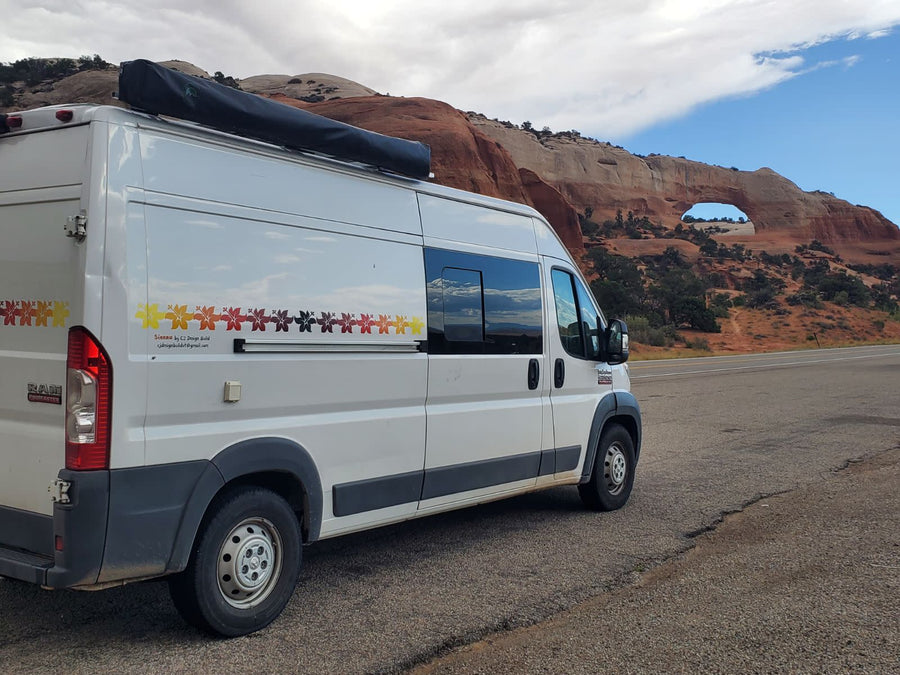 and a comfortable swiveling seat in a cozy camper van.|Open rear of an RV rental camper van