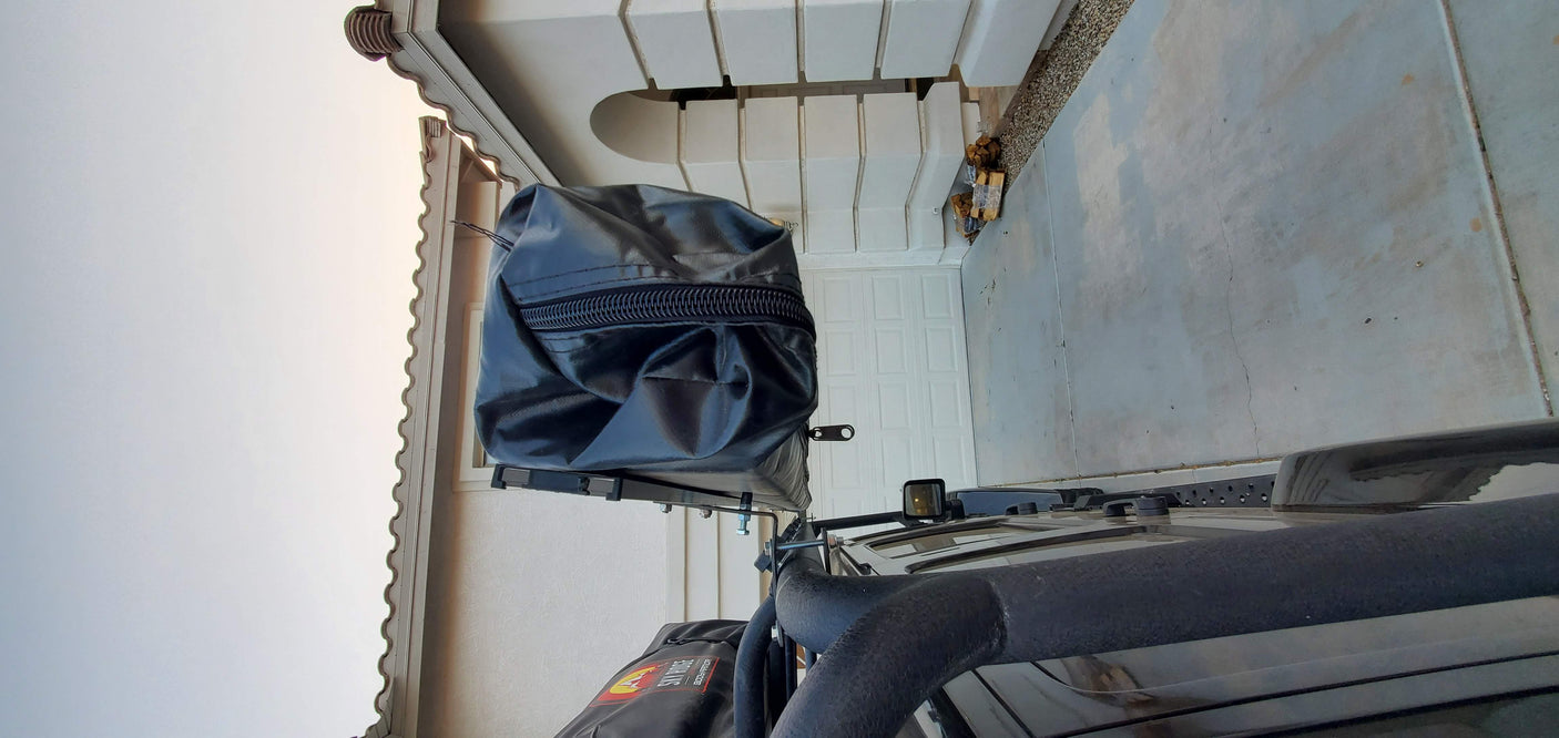 Overhead shot: black SUV with a roof-mounted camping tent in its travel cover, ready for your RV rental adventure.