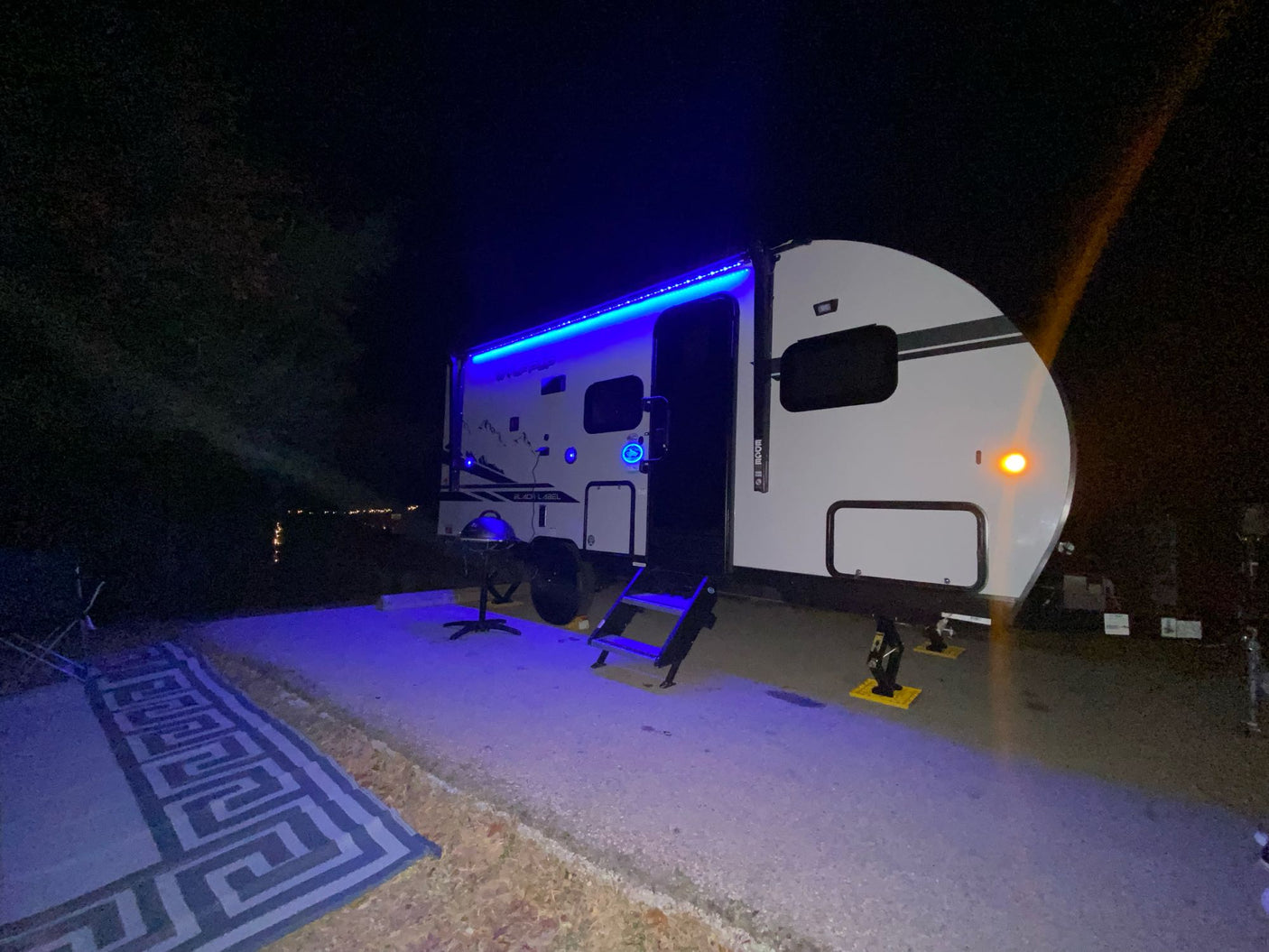 and ceiling vent.|RV rental interior: modern kitchen with black cabinets