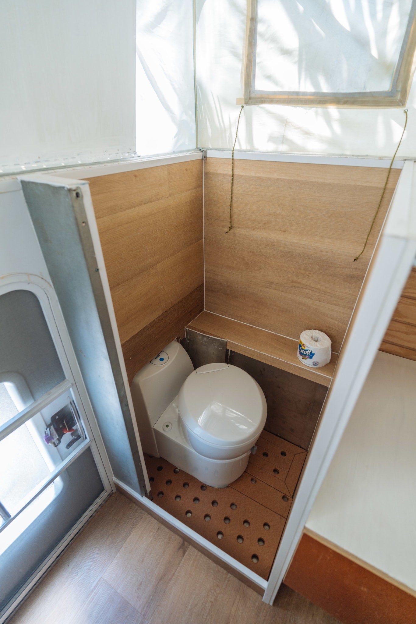 enjoying a serene sunset over the distant ocean.|Cozy RV rental bunk beds with sports-themed bedding inside a camper. Wooden walls and a fan make it comfortable for travel.|Inside an RV rental: a modern interior with kitchen sink