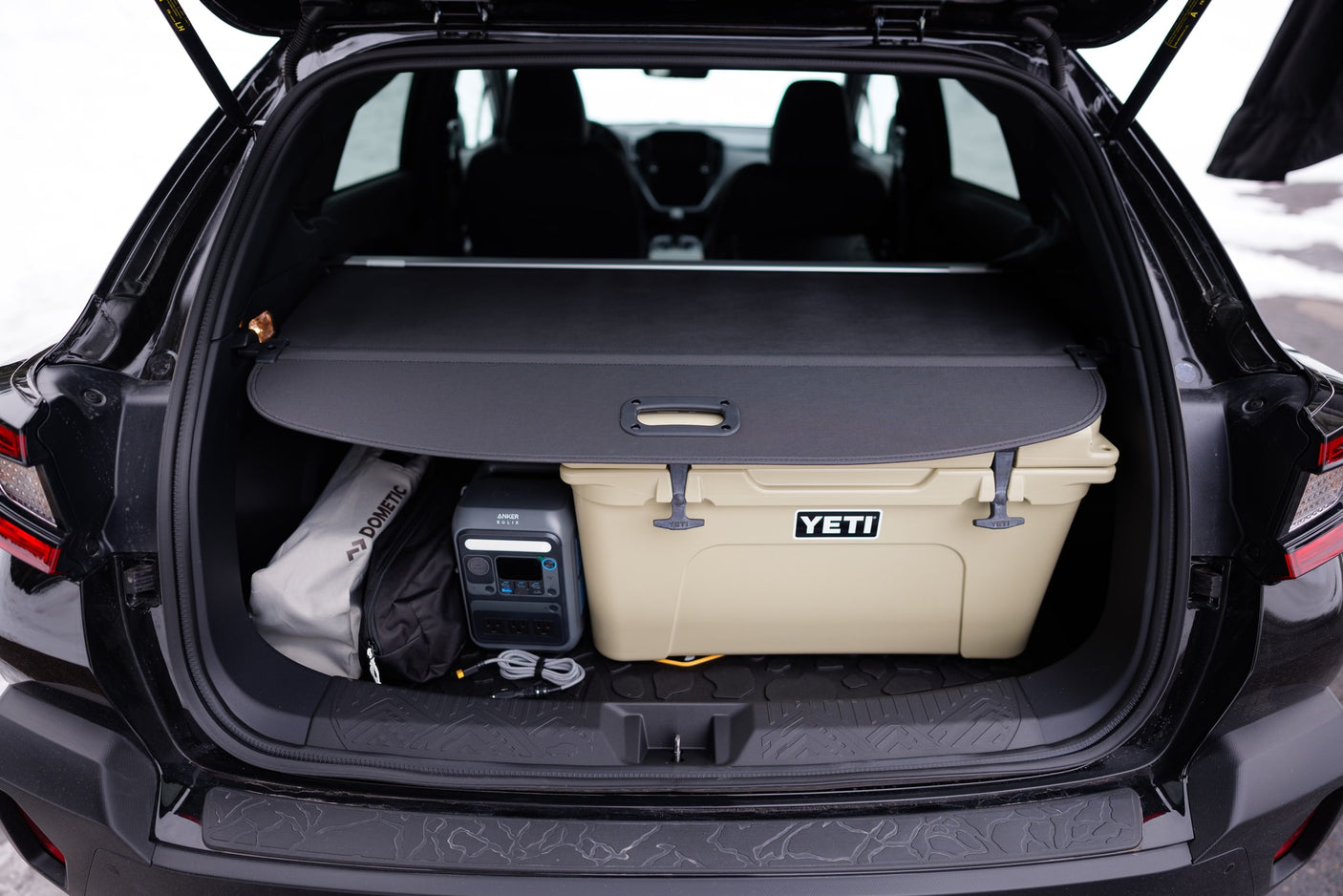 Stay powered & cool on adventures! Car trunk with Yeti cooler, Anker power station, Dometic gear. Perfect for trips, no RV rental needed.