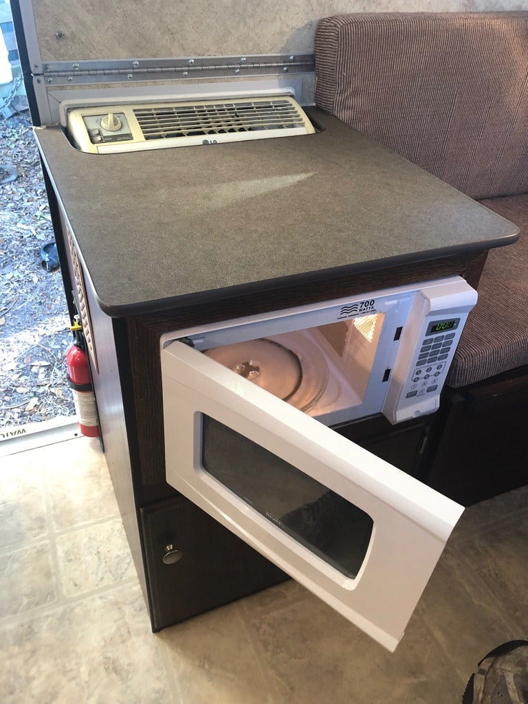 and lovely decor.|Interior of an RV rental: a compact living space with a dining table