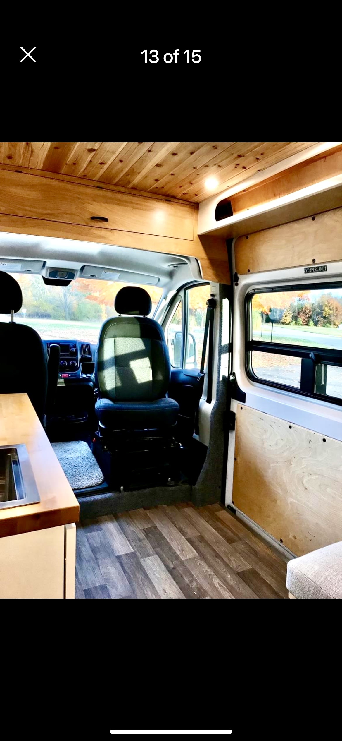 surrounded by vivid autumn foliage.|Step inside this cozy RV rental's custom interior: a comfortable bed