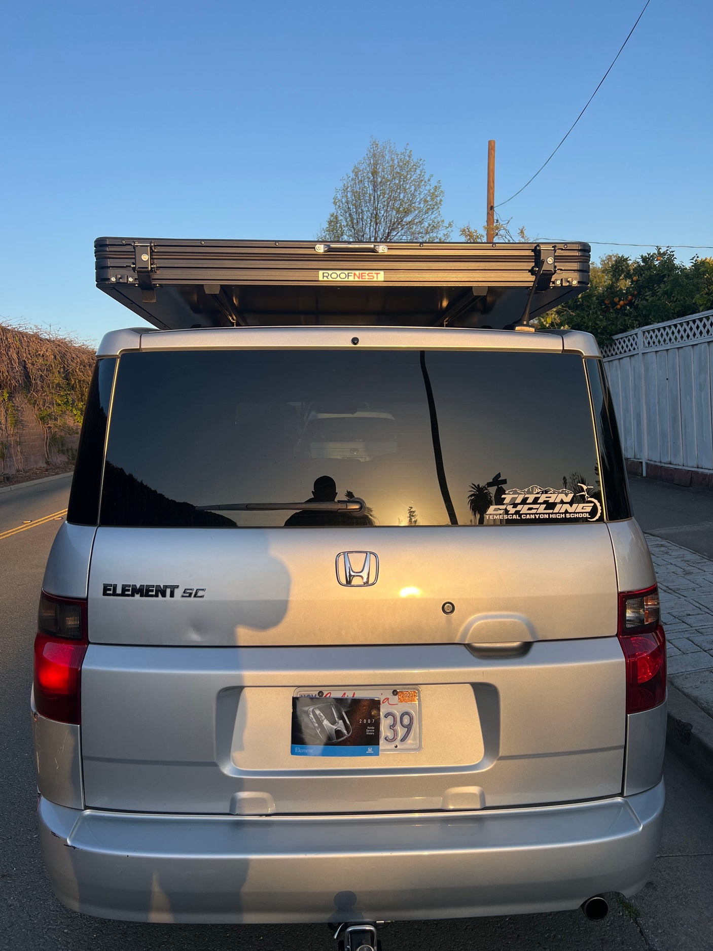 Rear of a silver Honda Element with a Roofnest rooftop tent. A compact adventure vehicle perfect for an RV rental experience.