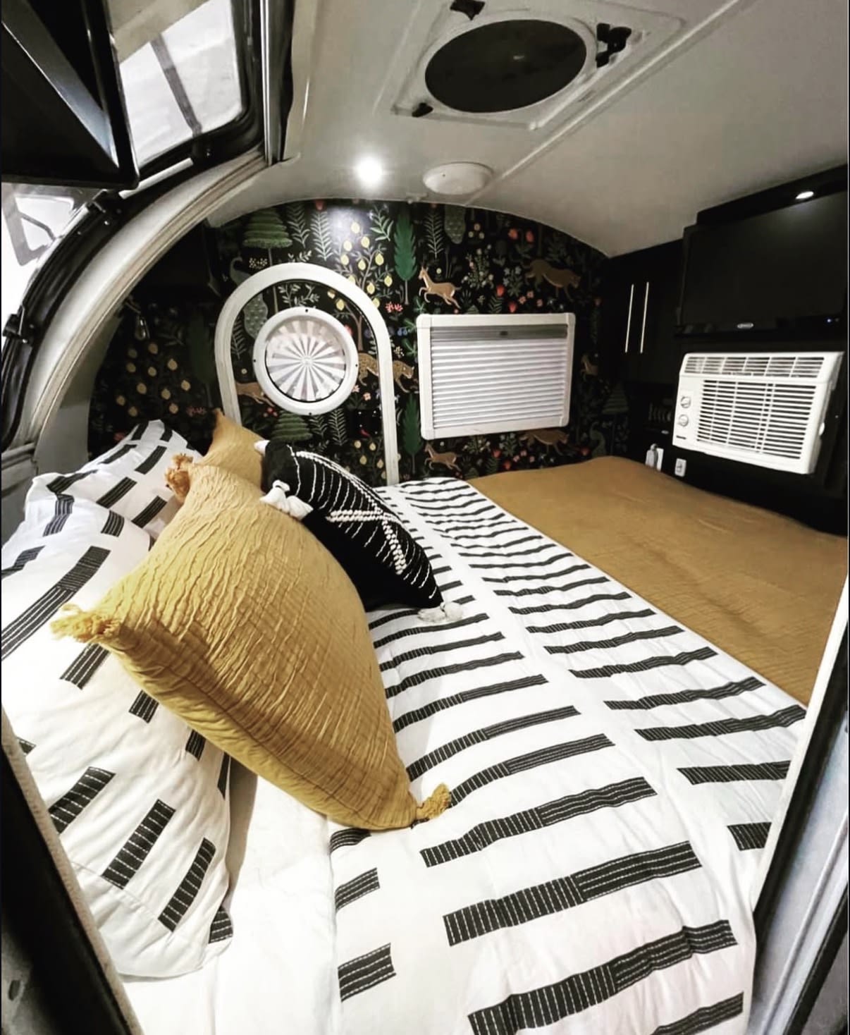 showing a bed & patterned door. Black & white rug out front