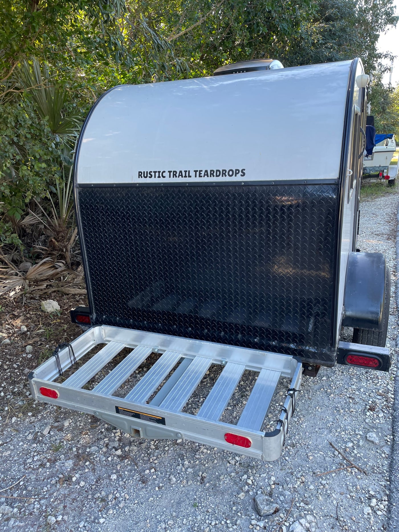 silver and black teardrop trailer with a rear cargo carrier for your gear.|RV rental interior: A gray — photo 3