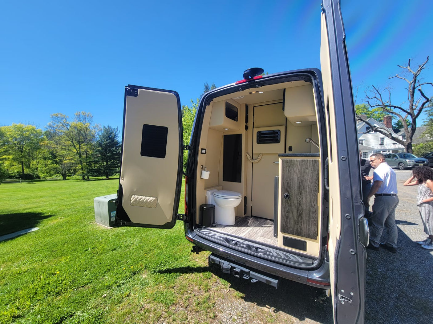 This RV rental showcases its compact, well-equipped interior with a toilet & kitchenette, ready for mobile living adventures.