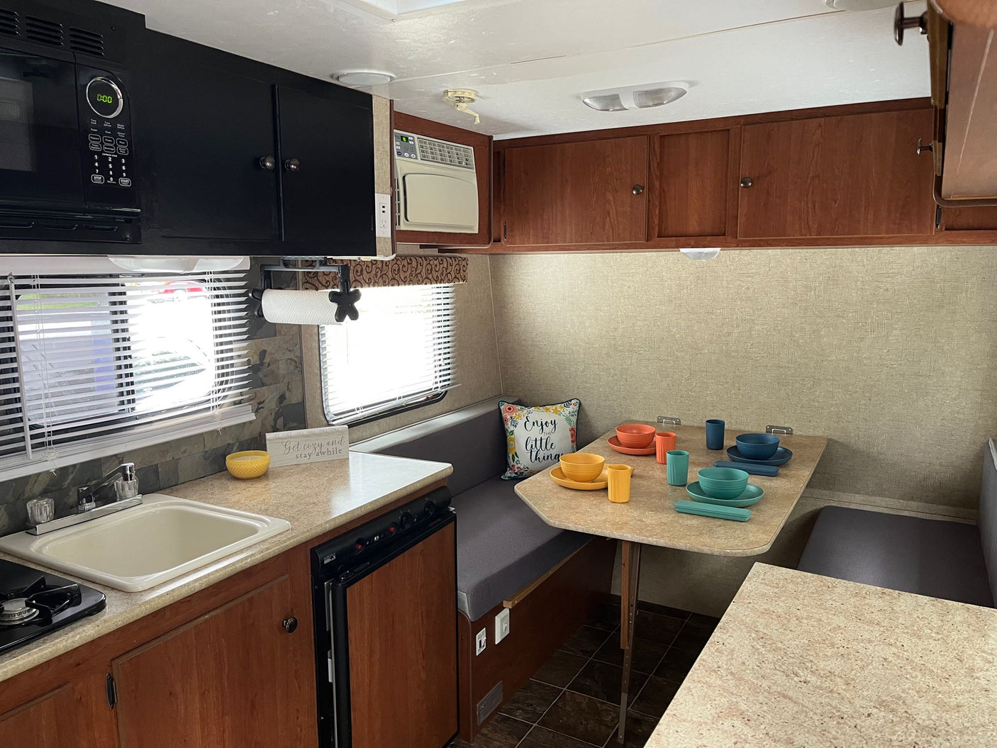 is ideal for RV rental.|RV rental interior: A compact kitchen with sink & microwave on left