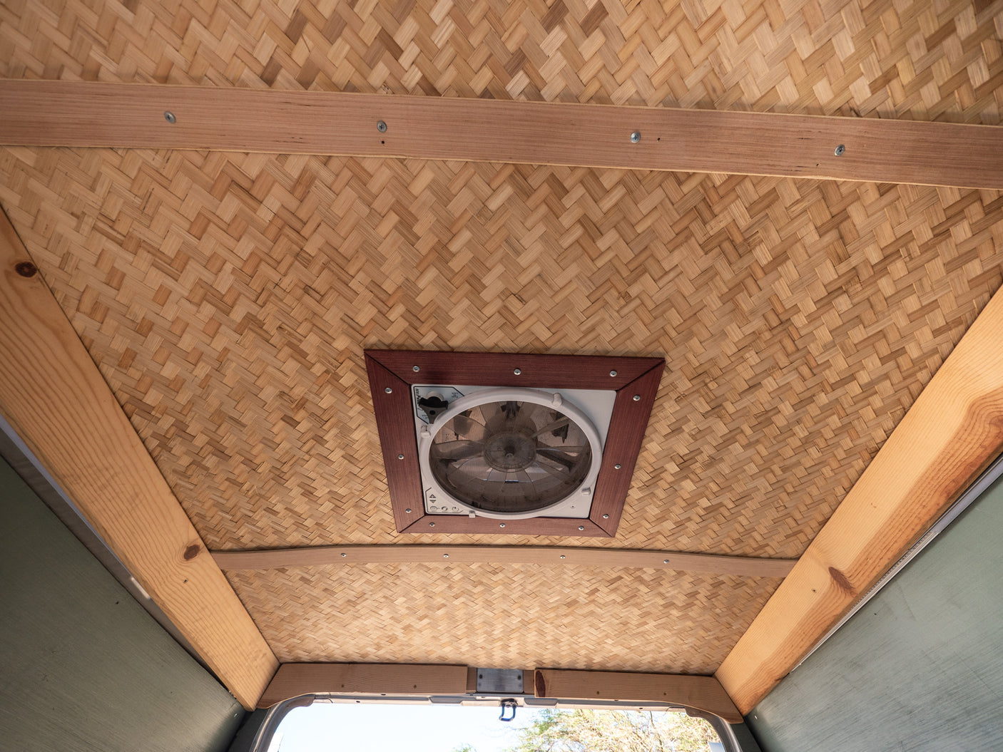 Experience comfort in this RV rental with a beautiful woven bamboo ceiling, natural wood beams, and a central ventilation fan.