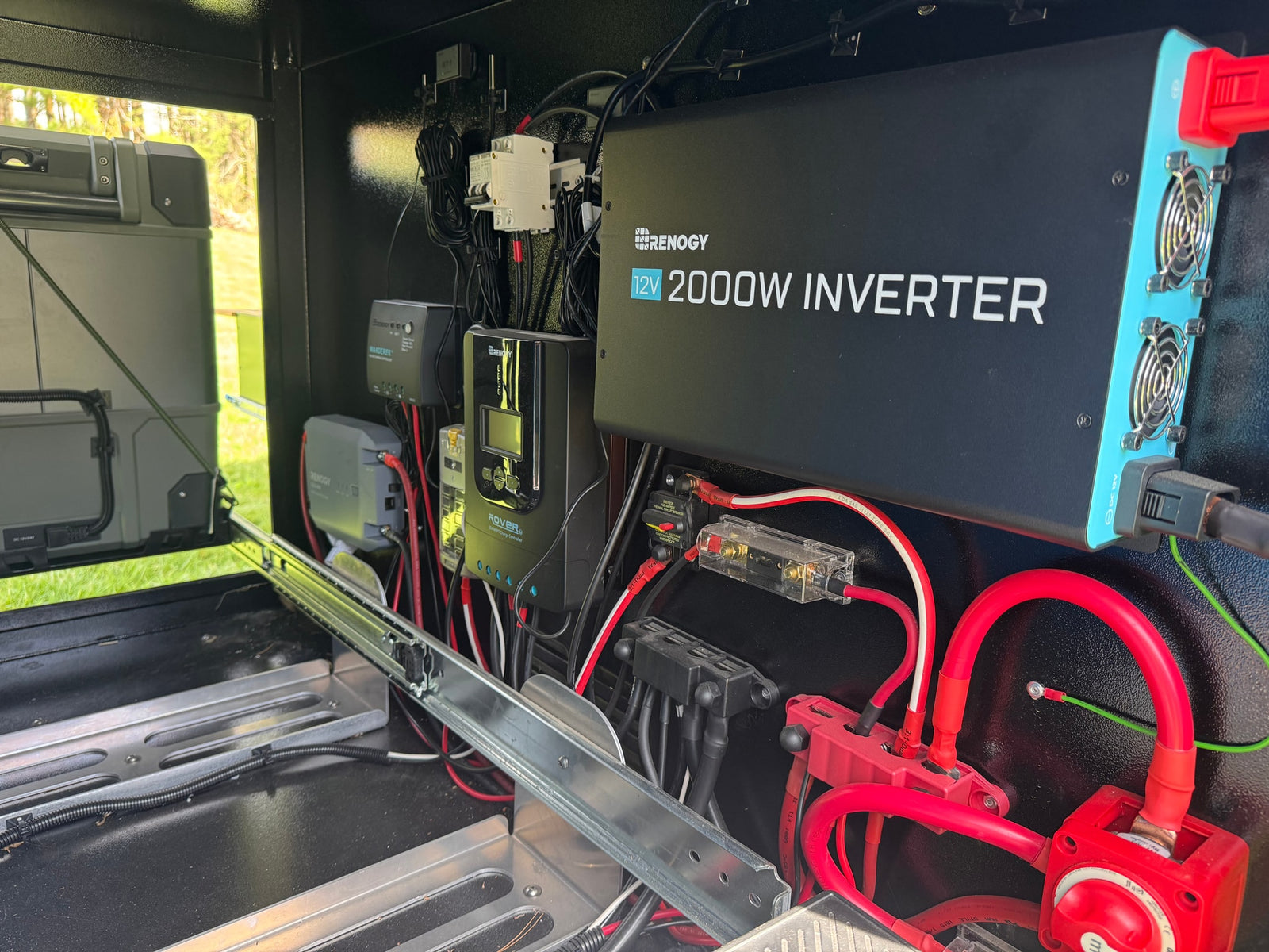 RV rental electrical system with Renogy 2000W inverter, solar charge controllers, and robust wiring for off-grid power.