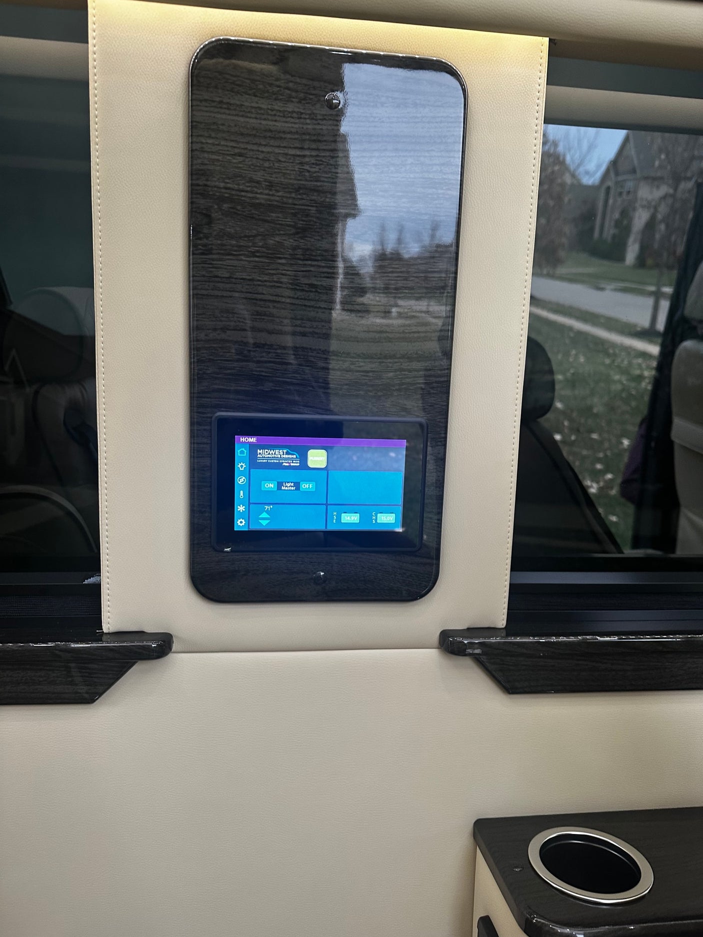 and media control panel for premium travel comfort.|Luxury RV rental interior: two cream