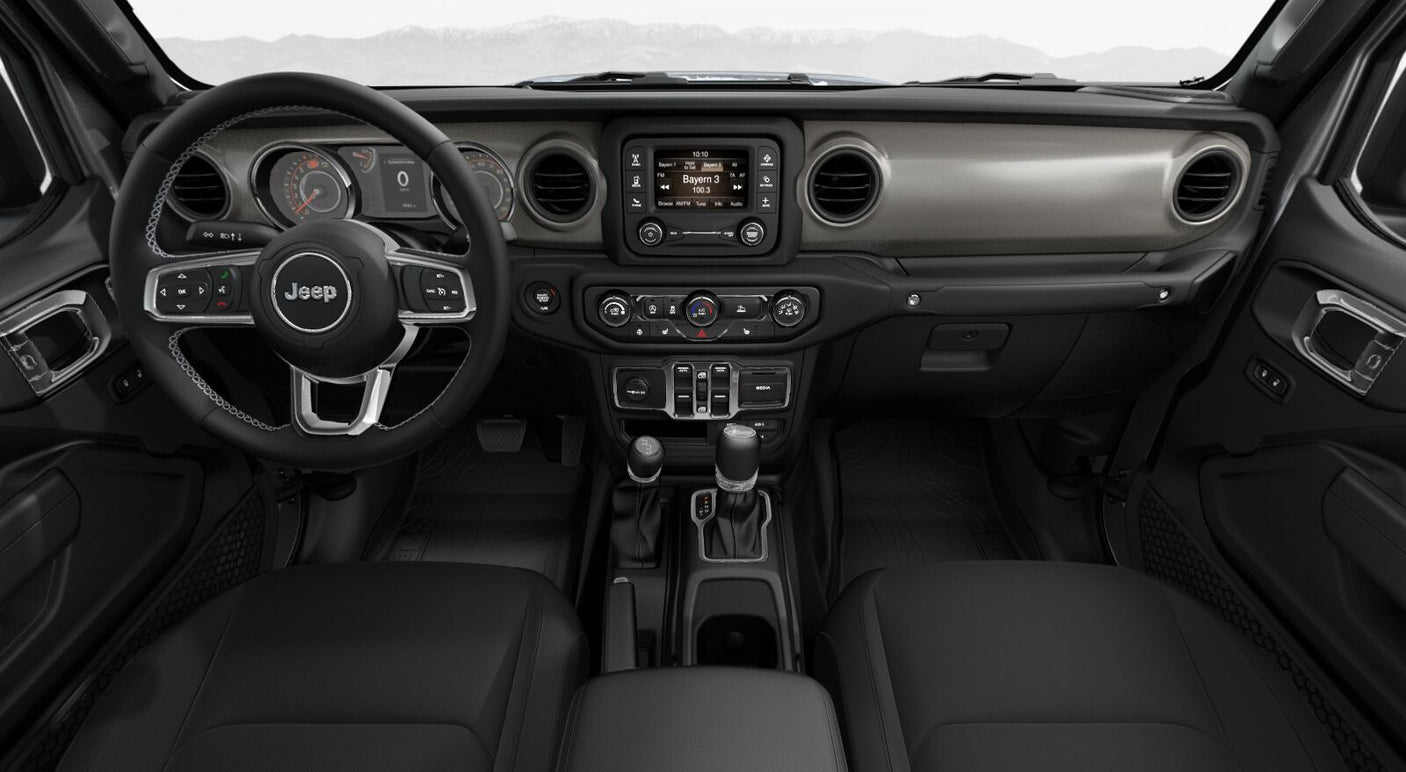 surrounded by red rock formations.|Modern car interior: Jeep dashboard