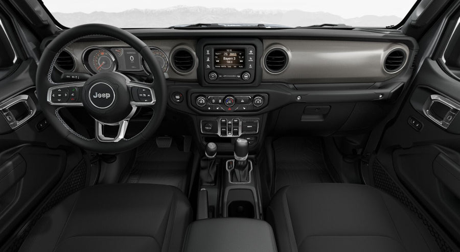 surrounded by red rock formations.|Modern car interior: Jeep dashboard