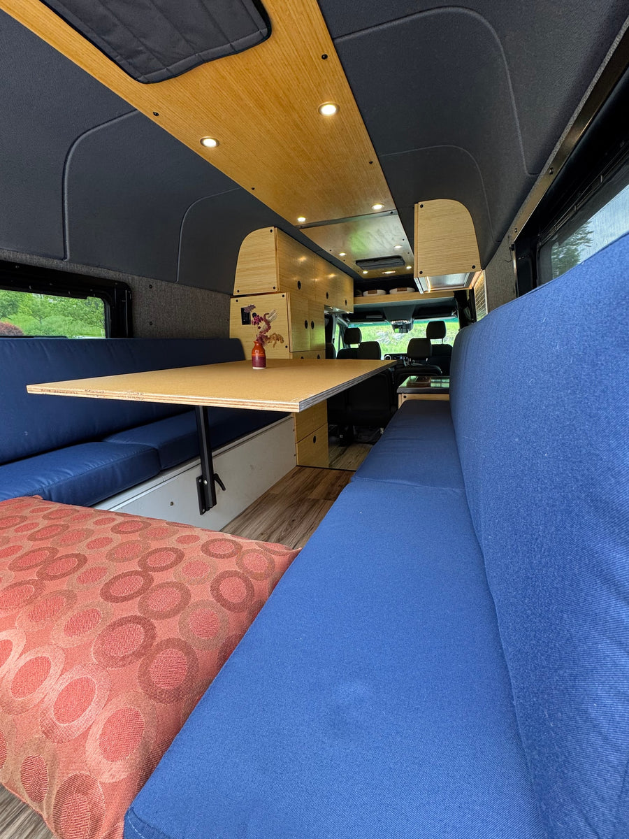 with a scenic view outside.|Grey RV rental van with two bicycles on its rear rack