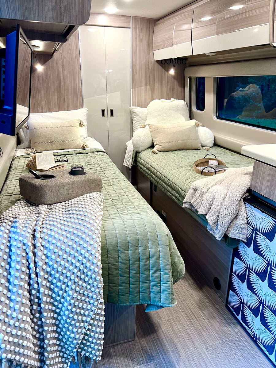 well-lit camper van with cozy seating.|Golden sunrise from our cozy RV rental. Misty fields and mountains welcome a new day on the road.|Step inside this modern rv rental with facing couches