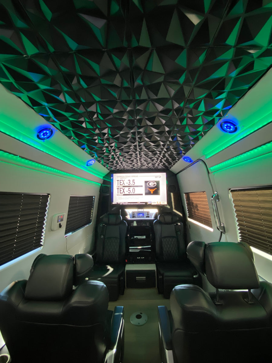 Experience our luxury rv rental! Featuring a modern geometric ceiling, vibrant LED lighting, plush seating, and a large sports display.