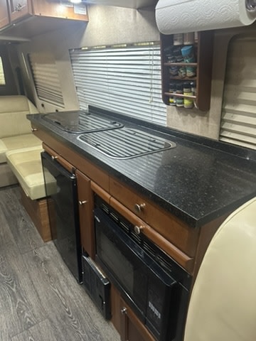 ready for adventure.|Silver RV rental van with its side door open