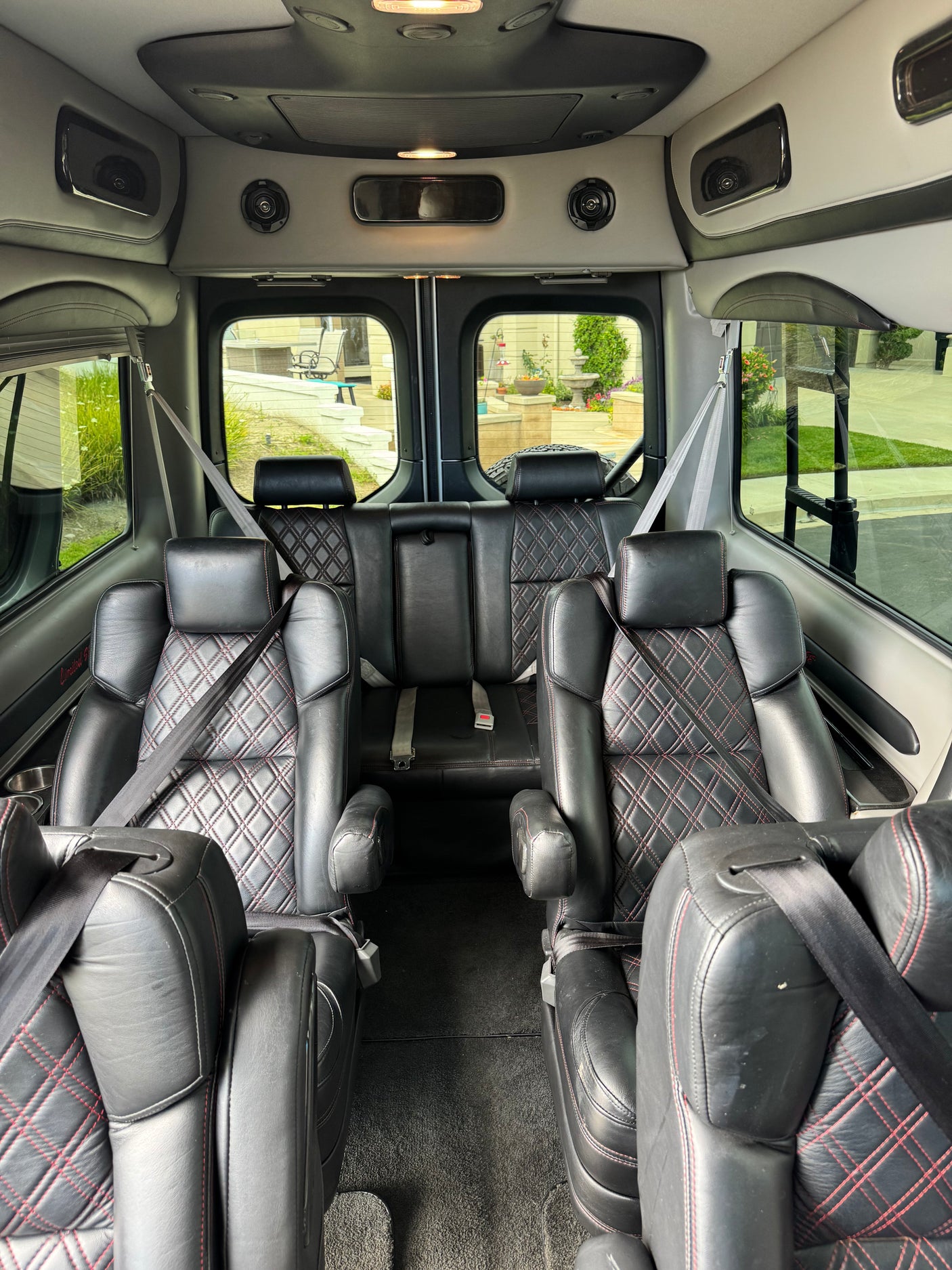 Luxurious black leather interior of an RV rental van with diamond stitching, ready for comfortable travel.