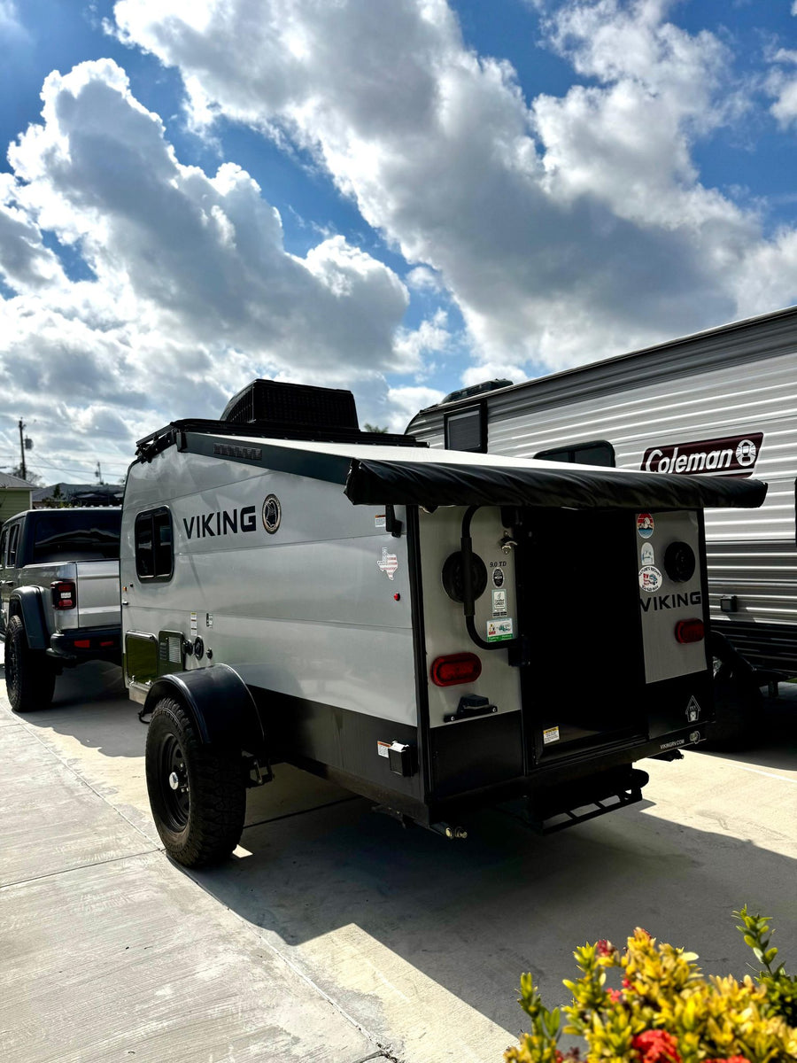 A gray Viking camper trailer attached to a Jeep Gladiator