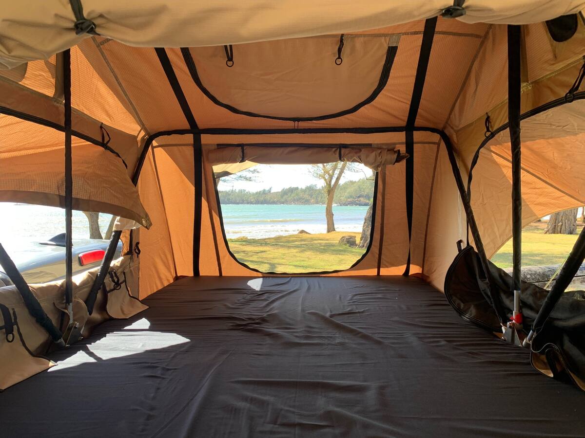 ready for a comfortable camping trip.|Inside a spacious rooftop tent