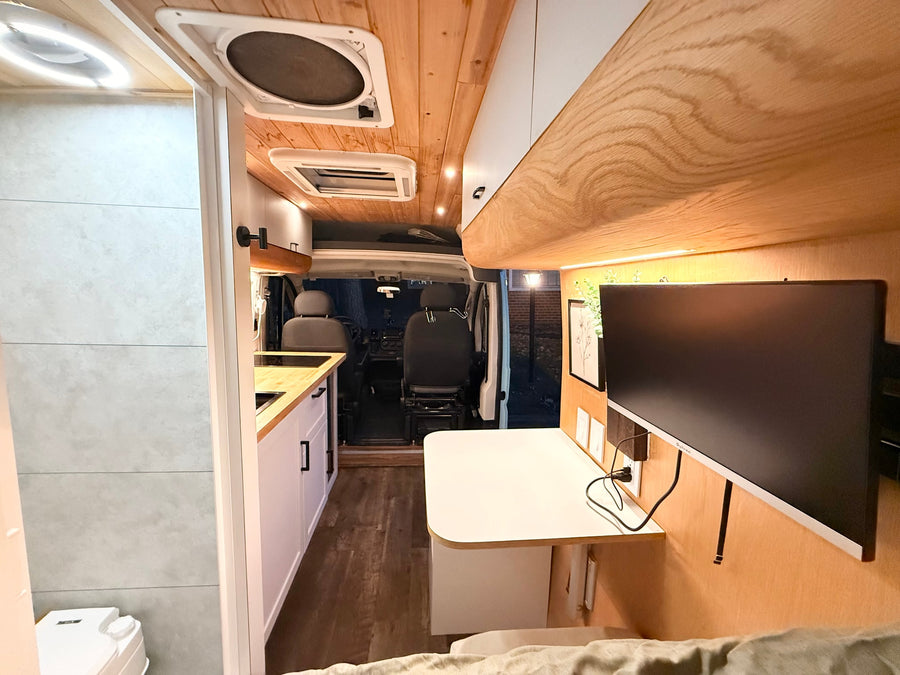 and hills in the background.|Discover your next rv rental adventure! This camper van boasts a bright