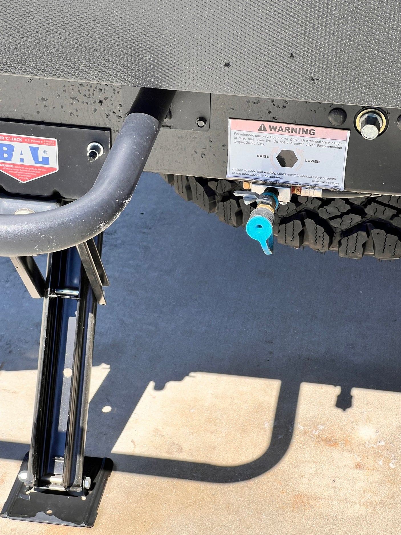 and 'EXTEND/RETRACT' controls for the automatic leveling/stabilizing jacks visible on its exterior panel.|RV rental exterior shows a water fill port
