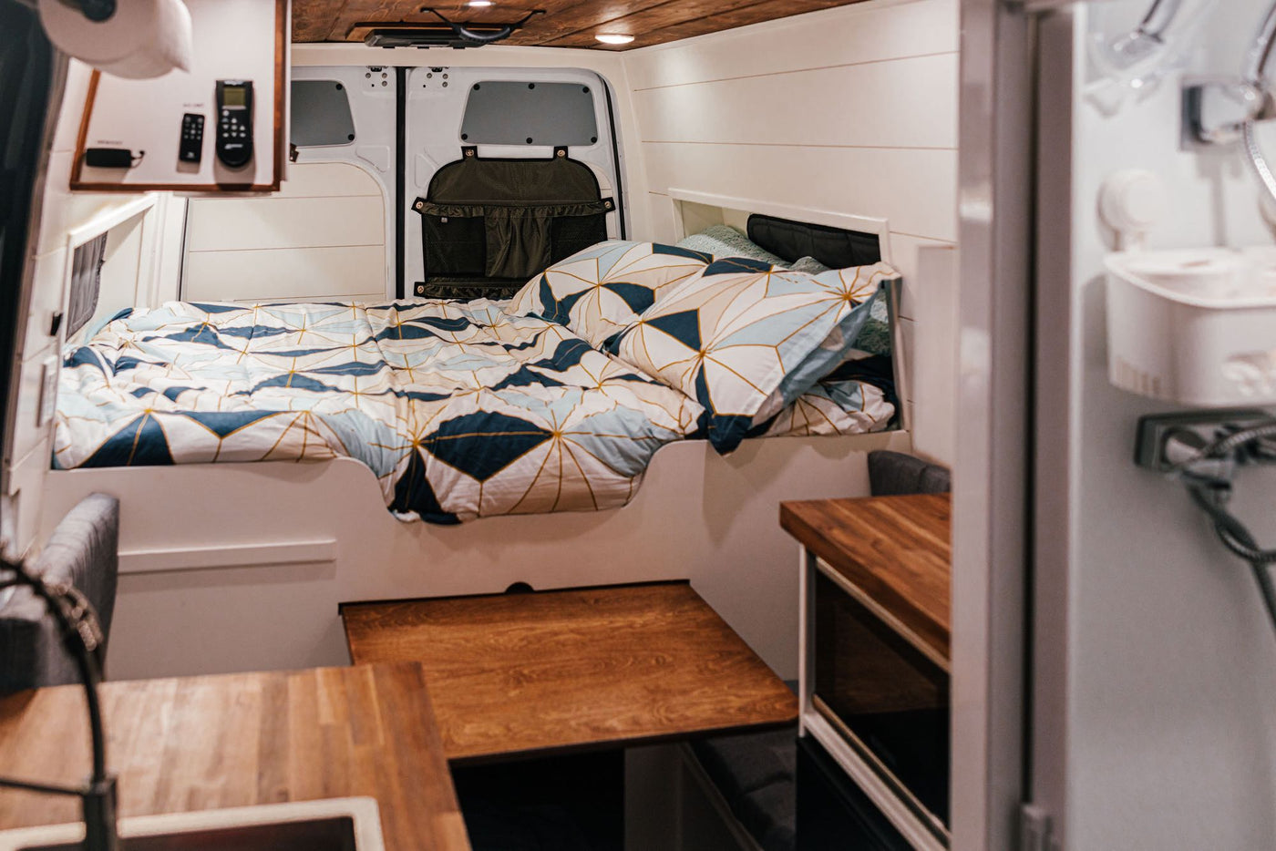 on a desert road with stunning red rock formations.|Cozy RV rental interior: bed — photo 3