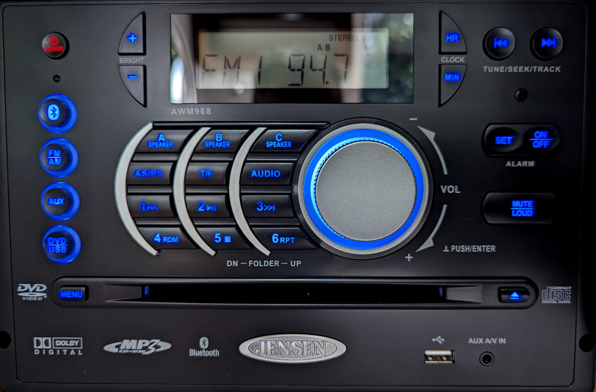 Jensen AWM968 RV multimedia stereo unit with blue backlit controls. Features include FM radio, DVD, USB, Bluetooth, ideal for an RV rental. — photo 10