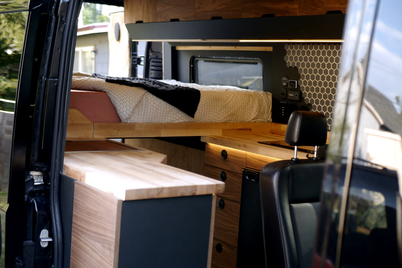 Modern RV rental interior with a cozy bed
