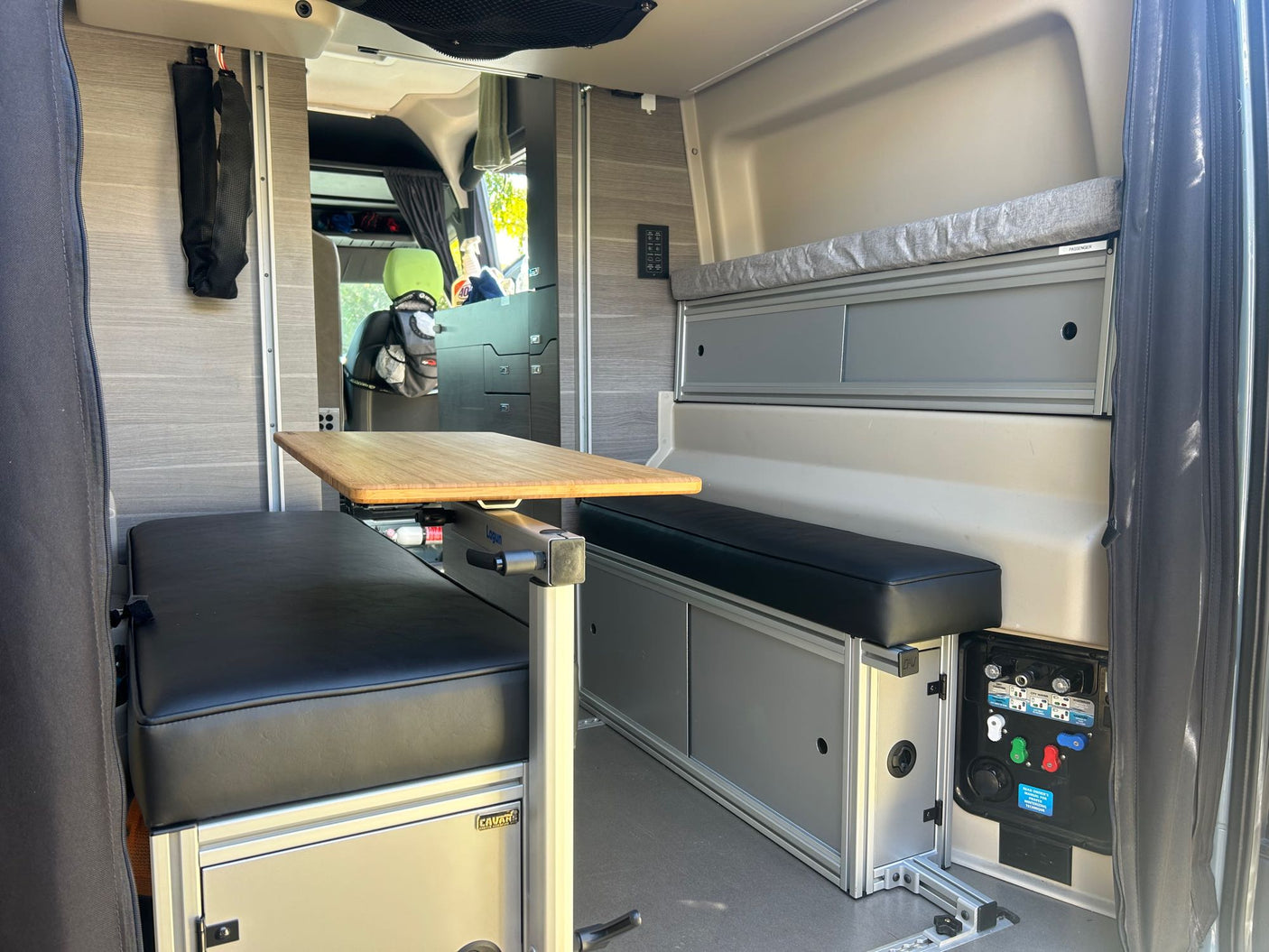 Spacious RV rental interior featuring a convertible dinette with comfy benches, adjustable table, and ample storage for your next adventure.