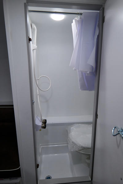 and netted overhead storage. Perfect for road trips!|A sleek white Rove Lite travel trailer