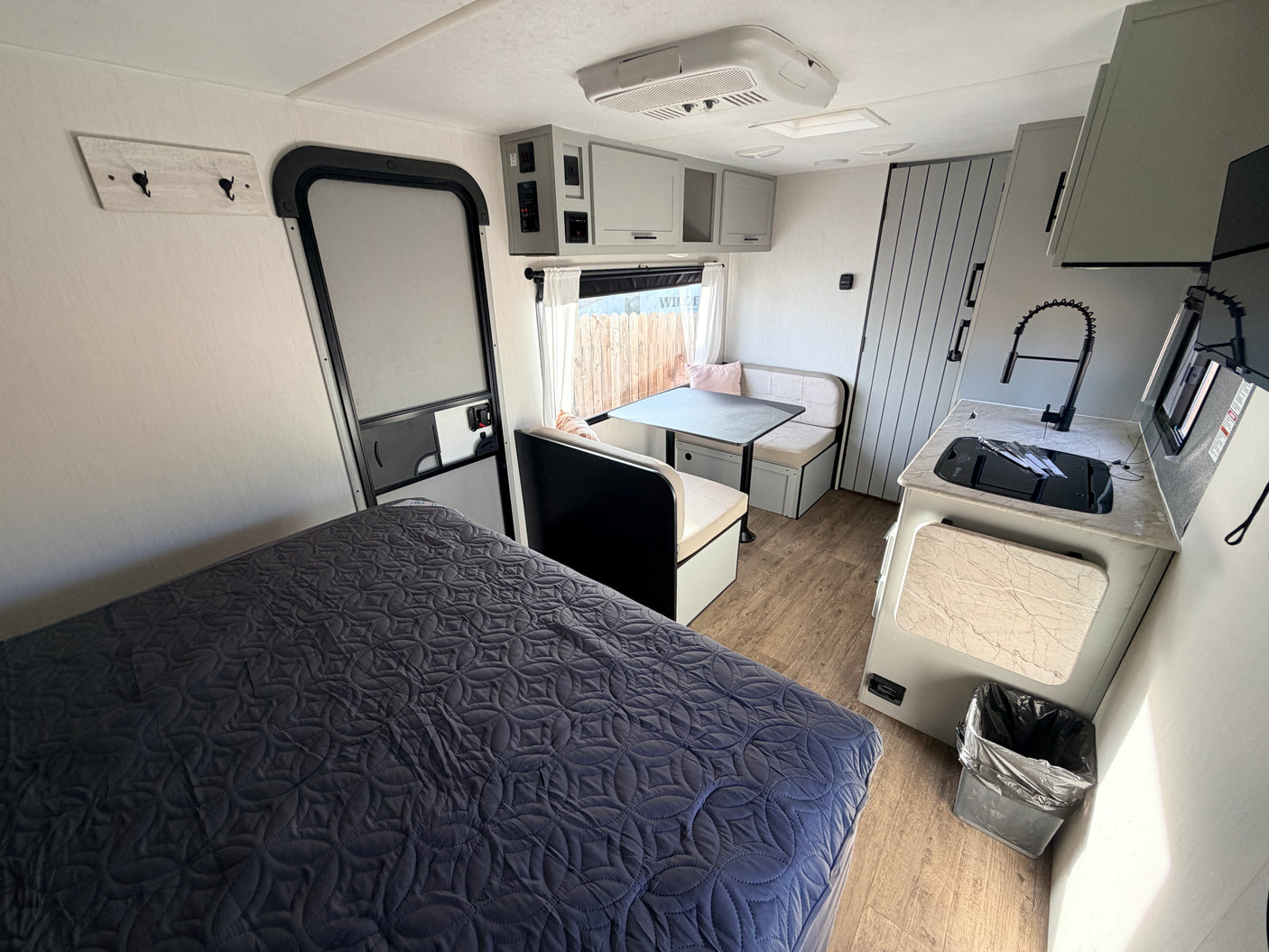 Experience comfort in this rv rental. Features a bedroom, kitchen, and dinette in a compact, modern interior.