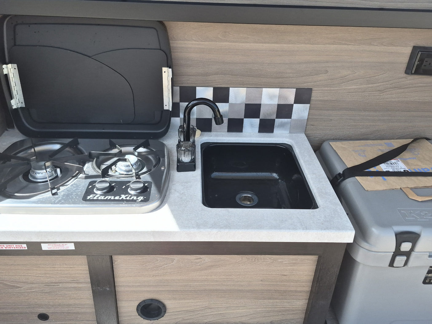 and control panel on the left.|Interior view of an **rv rental** showing a gray bed