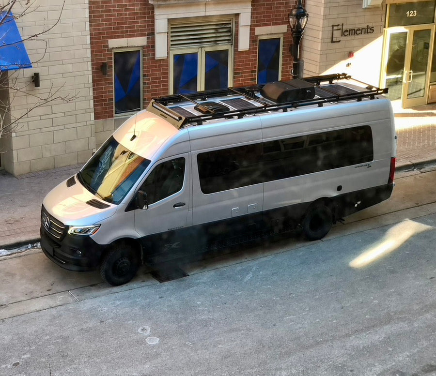 ready for adventure.|Silver Airstream camper van with roof rack