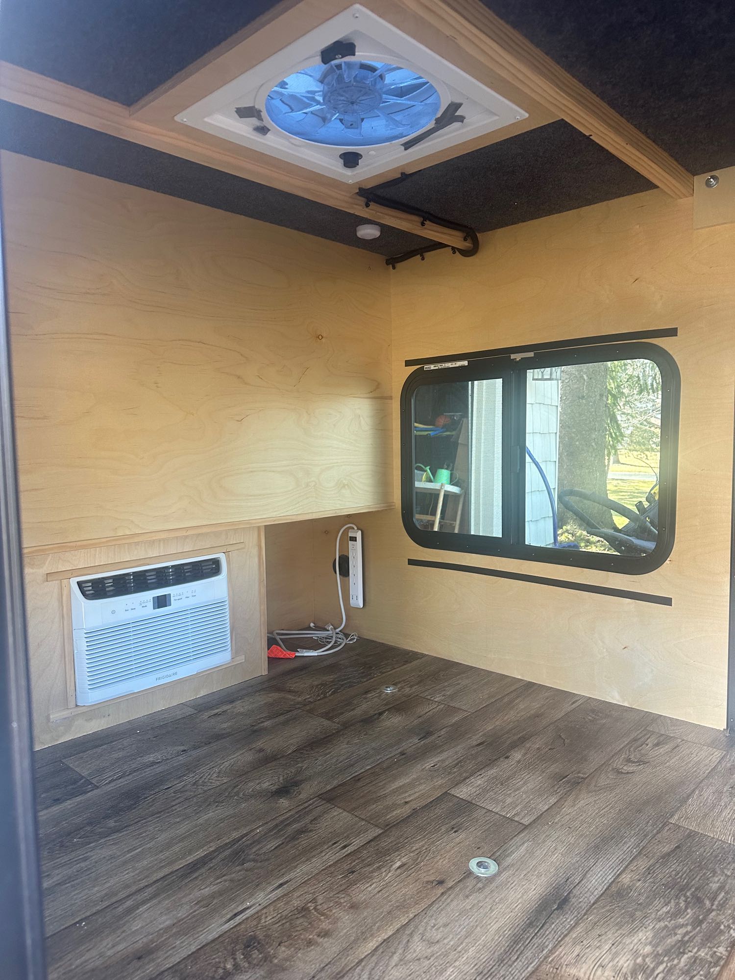 and front hitch.|Rear view of a grey teardrop camper