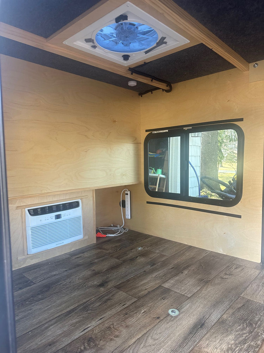 and front hitch.|Rear view of a grey teardrop camper