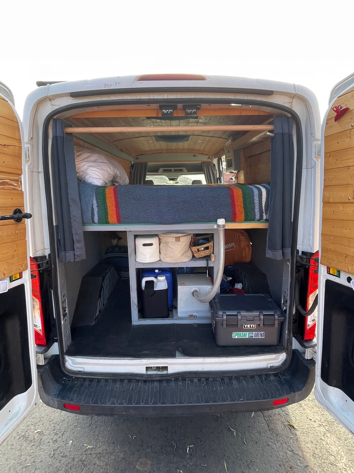 and a scenic window view.|This RV rental features a compact kitchen with a stove — photo 9