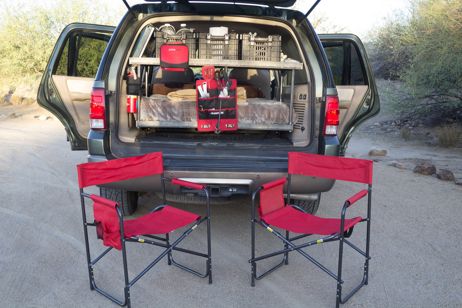 Organized SUV car camping setup with bed, storage, and chairs, ideal for an RV rental outdoor adventure.
