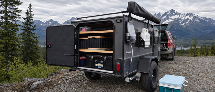 parked by a lake amidst lush mountains.|This RV rental
